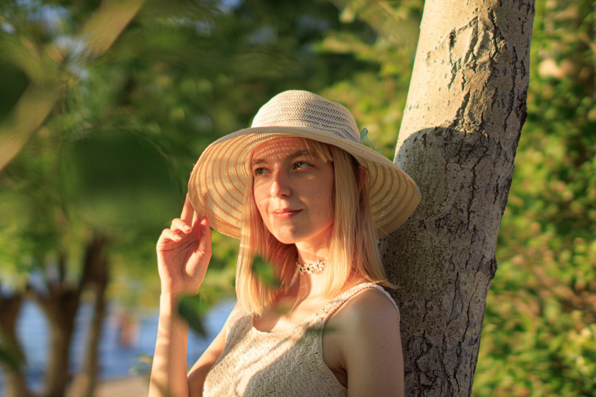 Woman contemplating in a sun hat in the sunshine.