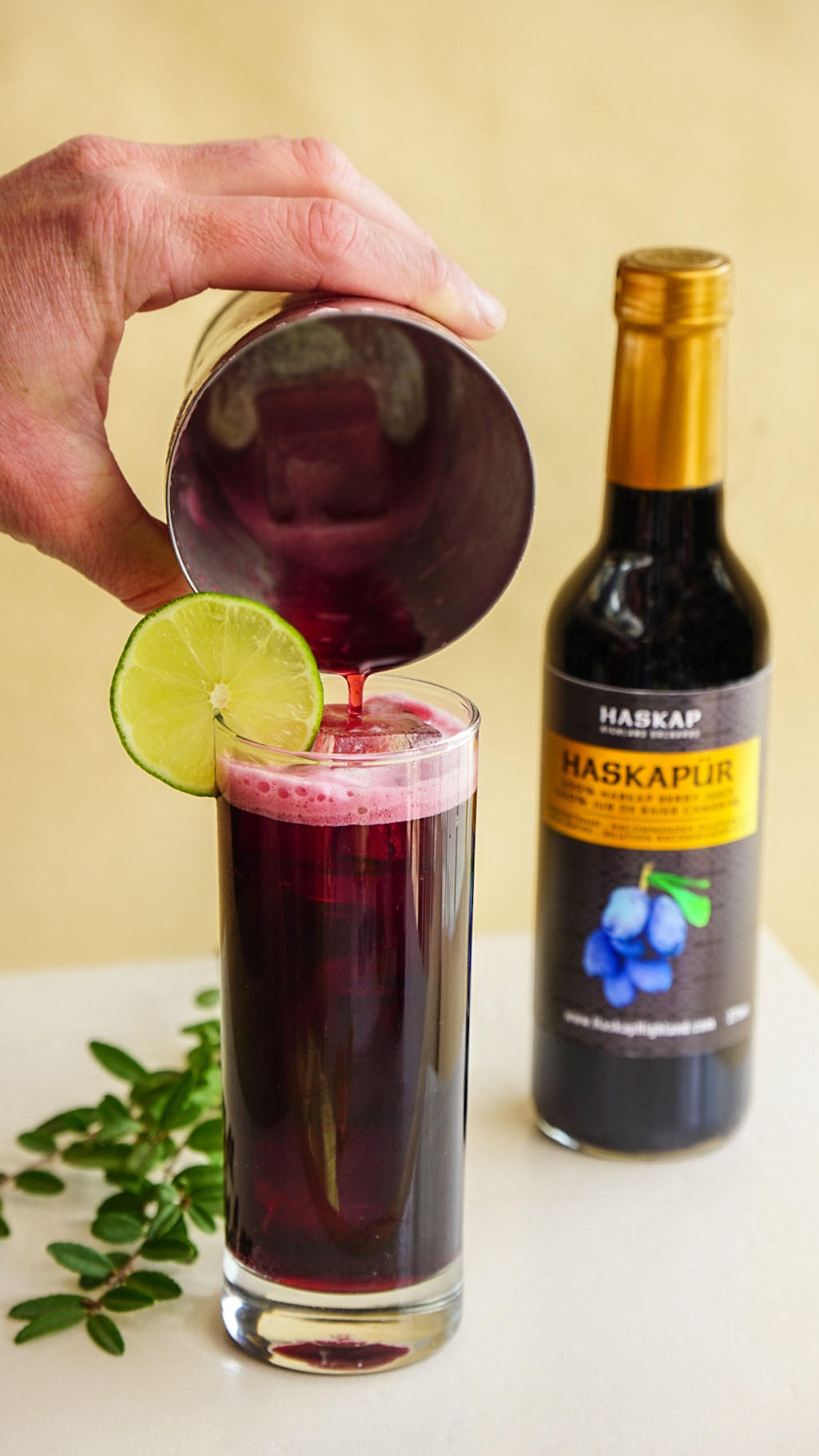 Haskap Pure Intentions Mocktail with bottle of Haskapur pure Haskap juice